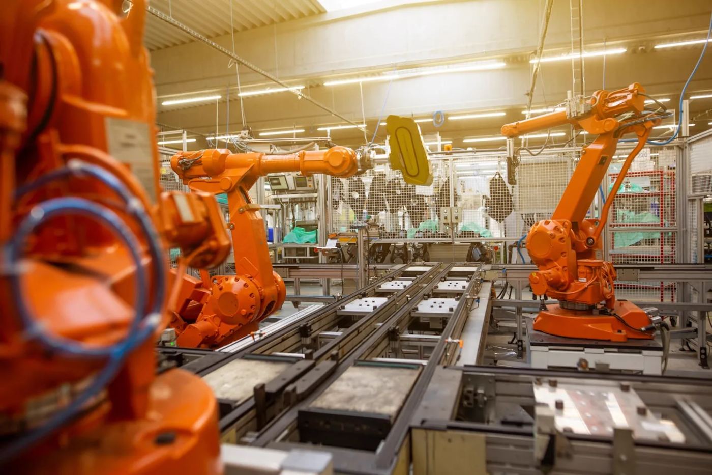 Industrial robot arms working along a production line